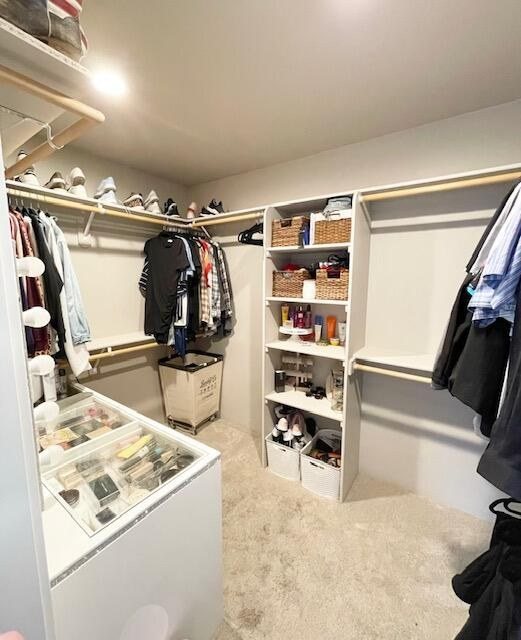 Walk-in closet with built-in shelving, double hanging and a drawer bank
