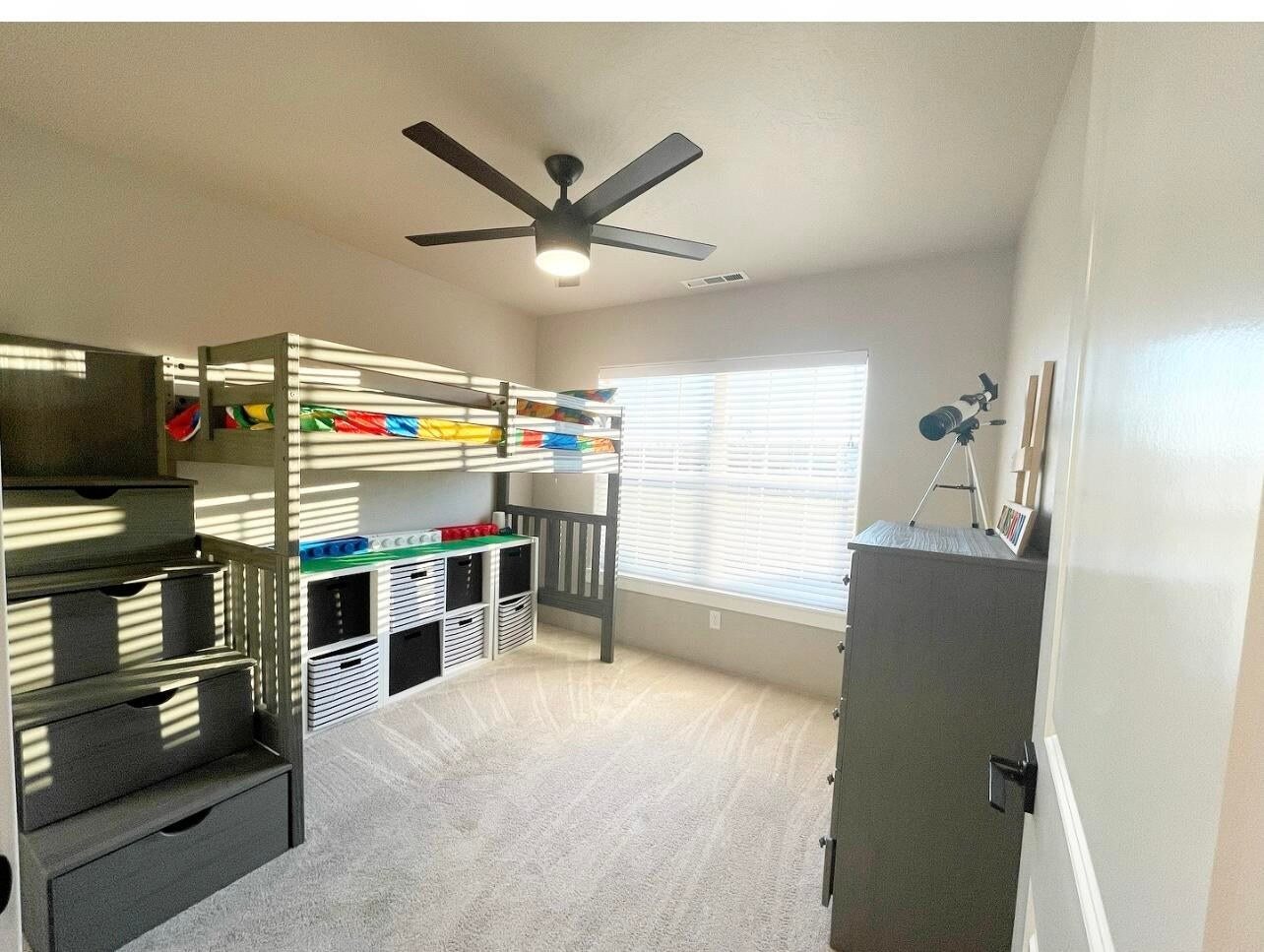 Bunk room with built-in bunks, shelving and under-step storage